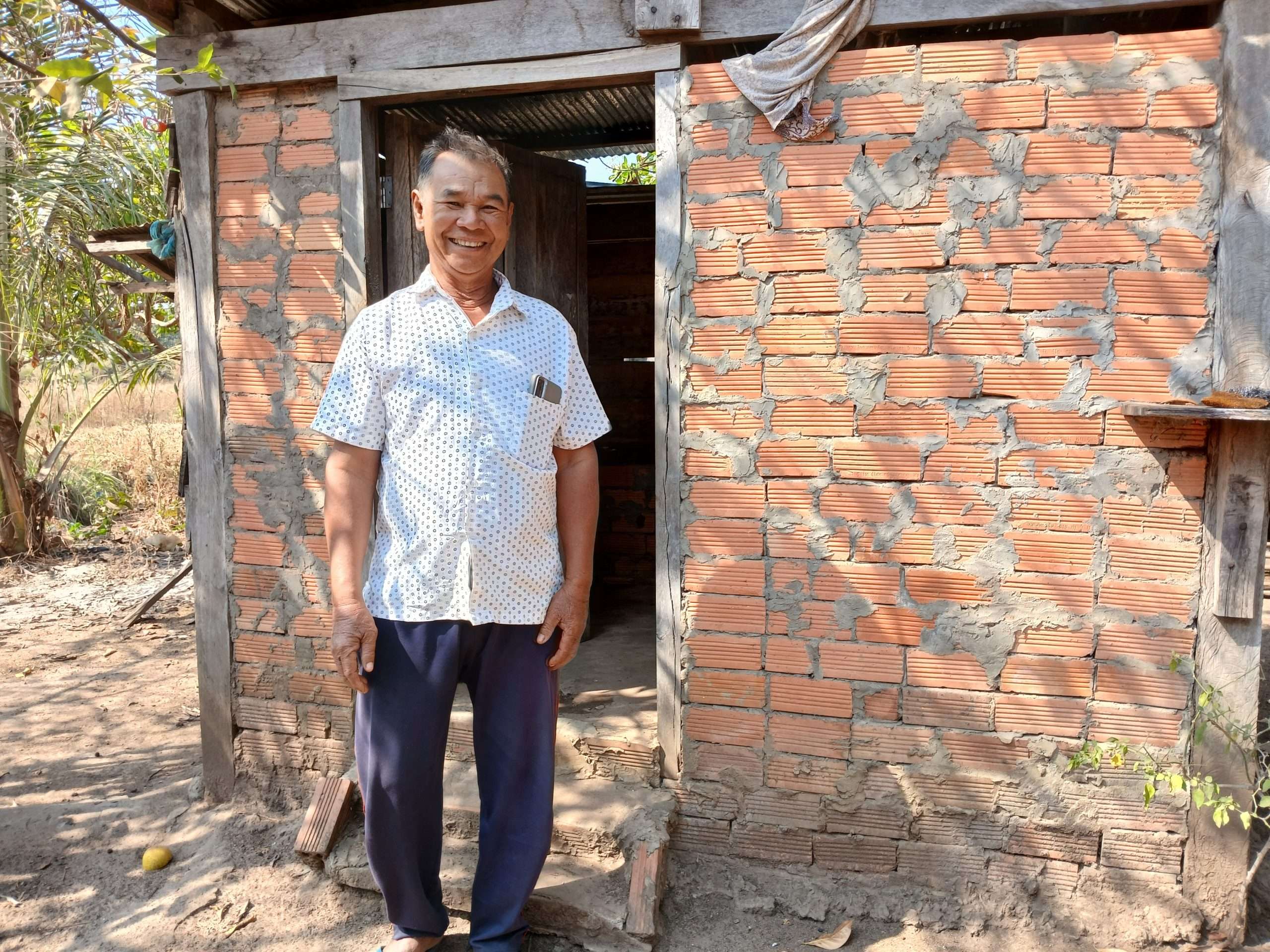 Vong shows his home latrine
